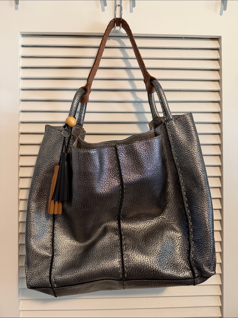 The Sak Metallic Pewter Tote with Brown Handles and Tassel Accent